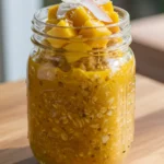 tropical turmeric overnight oats in a jar with fruit toppings