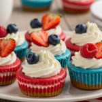 Red, White and Blue Mini Cheesecakes topped with whipped cream and berries