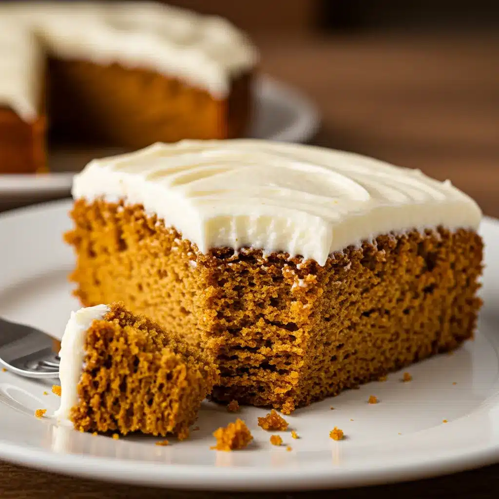 A close-up, isolated slice of moist 3-ingredient pumpkin spice cake with cream cheese frosting on a white background.