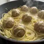 Homemade Easy Garlic Butter Meatballs with Creamy Linguine in a rustic bowl, garnished with fresh parsley, ready to enjoy.